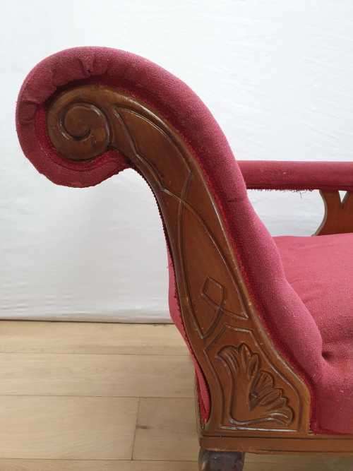 An Edwardian rail-back upholstered Chaise Lounge