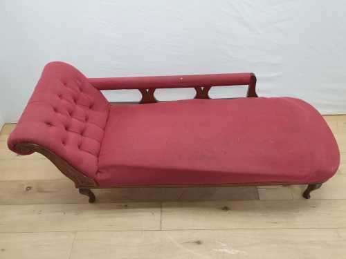 An Edwardian rail-back upholstered Chaise Lounge