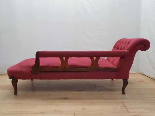 An Edwardian rail-back upholstered Chaise Lounge