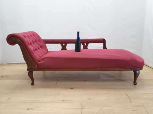 An Edwardian rail-back upholstered Chaise Lounge
