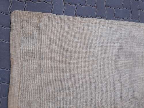 A large beige coloured wool carpet