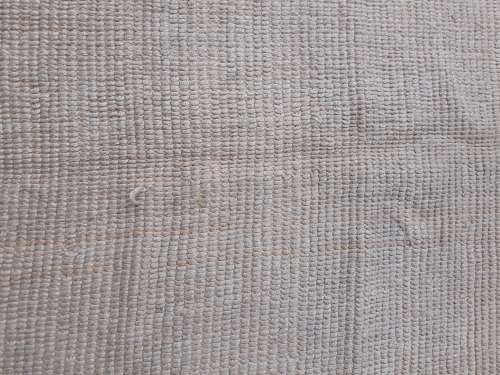 A large beige coloured wool carpet