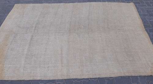 A large beige coloured wool carpet