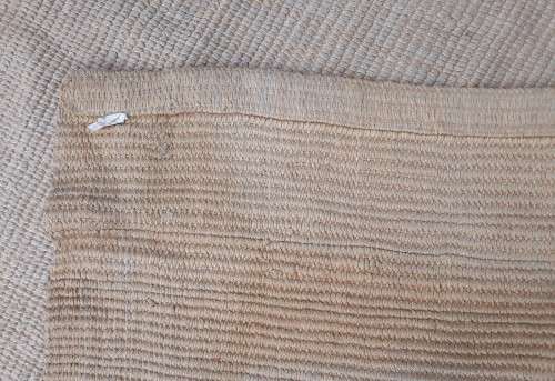 A large beige coloured wool carpet