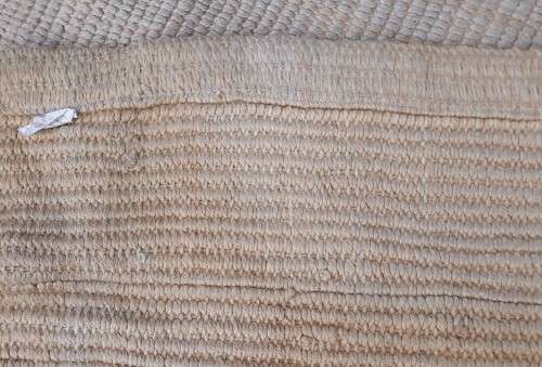 A large beige coloured wool carpet