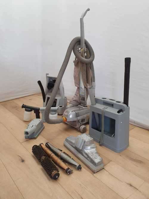 A Kirby vacuum cleaner in working order with extra attachments