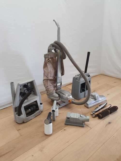 A Kirby vacuum cleaner in working order with extra attachments