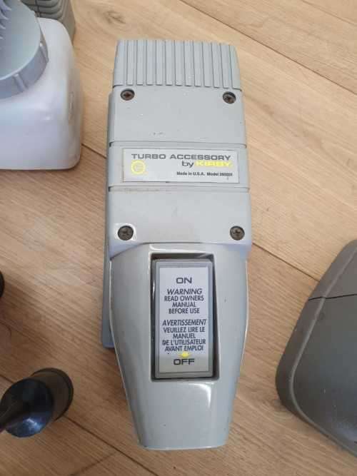A Kirby vacuum cleaner in working order with extra attachments