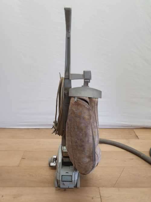 A Kirby vacuum cleaner in working order with extra attachments