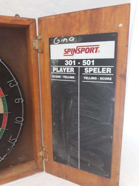 An awesome Unicorn Dart board in a wood cabinet
