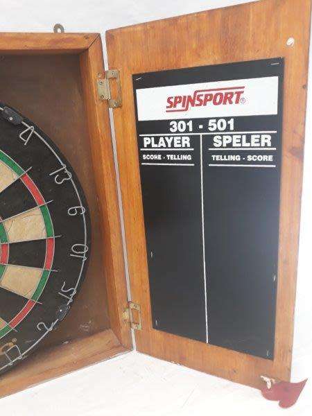 An awesome Unicorn Dart board in a wood cabinet