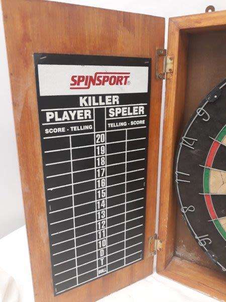 An awesome Unicorn Dart board in a wood cabinet