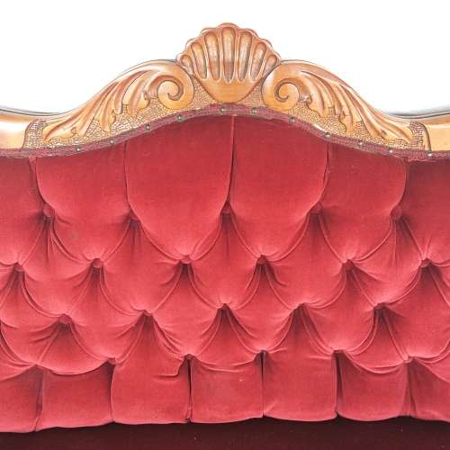 A lovely antique mid-century two-seater carved English Teak red velvet button-back sofa