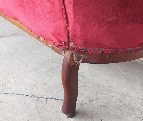 A lovely antique mid-century two-seater carved English Teak red velvet button-back sofa