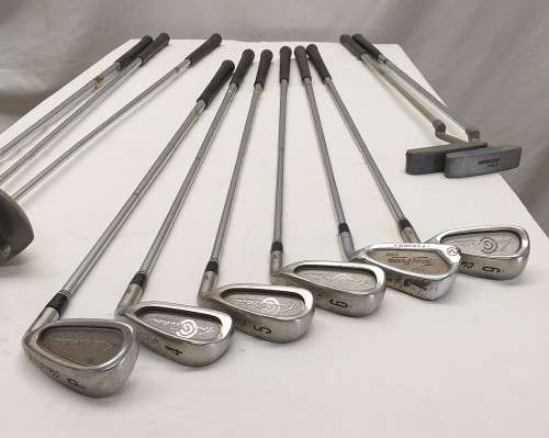 A collection of 11x assorted golf clubs, including irons, woods/ drivers and two putters