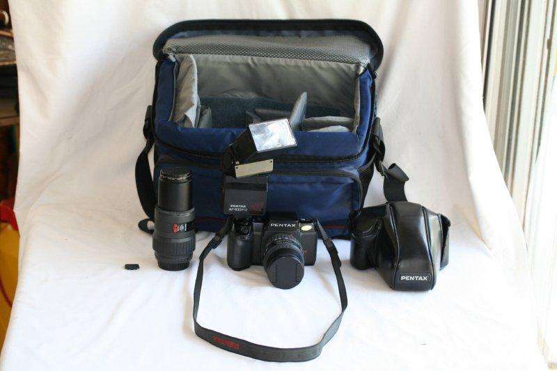 A NICE PENTAX CAMERA, LENSES, FLASH AND LOWEPRO CAMERA BAG!!! VERY NICE STUFF THAT STILL WORKS...