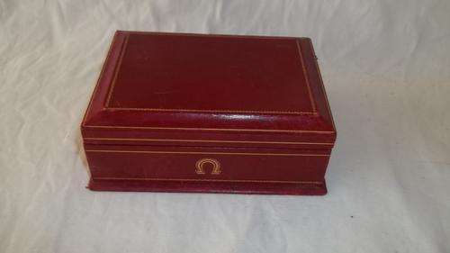 AN AMAZING ORIGINAL BURGUNDY OMEGA WATCH BOX WITH BROWN SUEDE LINING AND GOLD LOGO'S