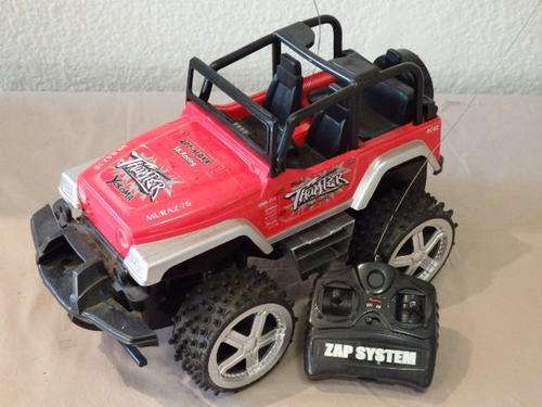 AN AWESOME ALL TERRAIN RED RADIO CONTROLLED JEEP WITH REMOTE CONTROL.