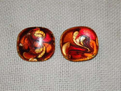 A VERY UNUSUAL PAIR OF LADIES CLIP ON EARRING WITH A LACQUERED COVERING IN RED, ORANGE, GOLD & BROWN
