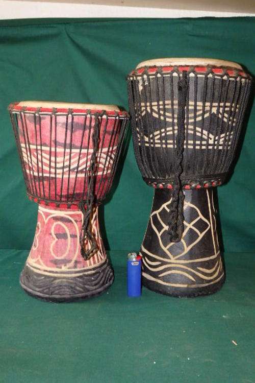AN AWESOME PAIR OF HANDMADE AFRICAN DJEMBE DRUMS WITH HAND ENGRAVED DESIGN DETAILING