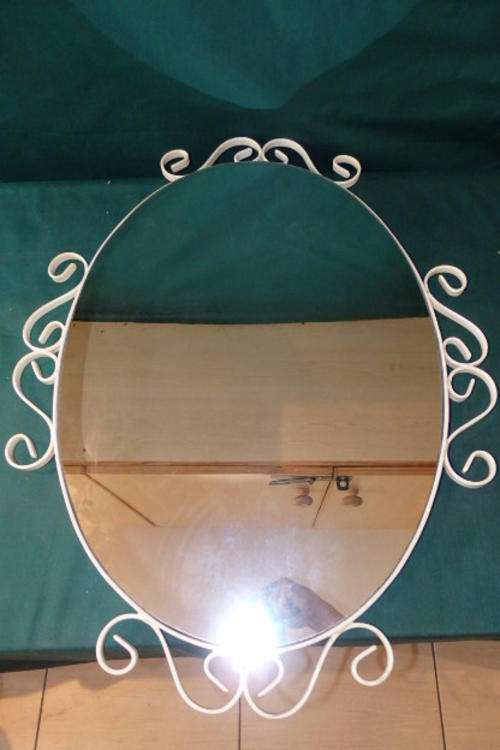 A FANTASTIC LARGE OVAL MIRROR IN A WHITE METAL FRAME WITH "TWIRLED" DESIGN VECTORS