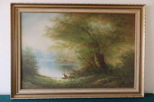AN EXQUISITE FRAMED ORIGINAL OIL ON BOARD PAINTING OF A YOUNG MAN FISHING IN A LAKE UNDER THE TREES