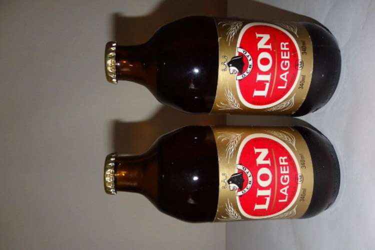 TWO AWESOME AND QUITE RARE "UNOPENED" VINTAGE LION LAGER BEERS IN THE 340ml DUMPY BOTTLES