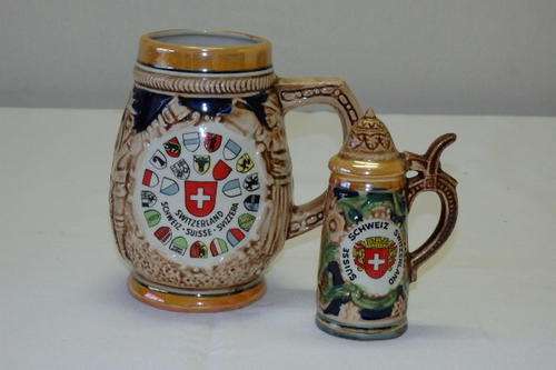 TWO AWESOME "SWITZERLAND" CERAMIC STEIN ORNAMENTS INCLUDING A TANKARD AND SALT CELLAR