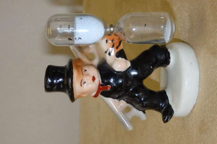 AN AMAZING ANTIQUE (1893 TO 1923) PORCELAIN EGG TIMER FIGURINE OF A CHIMNEY SWEEP