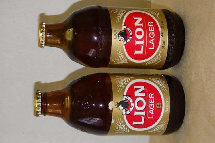 TWO AWESOME AND QUITE RARE "UNOPENED" VINTAGE LION LAGER BEERS IN THE 340ml DUMPY BOTTLES
