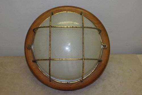 AN AWESOME VINTAGE ROUND BULKHEAD LIGHT MOUNTED ON A WOODEN BASE WITH A GLASS DOME & METAL FRAME