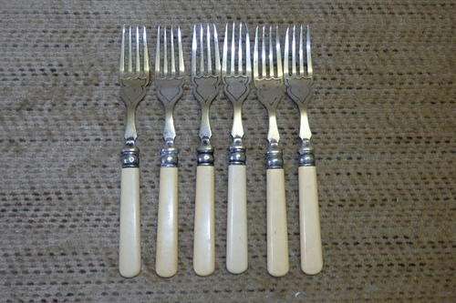 AN EXQUISITE SET OF SIX VINTAGE BONE HANDLE STYLE SILVER PLATED FISH FORKS