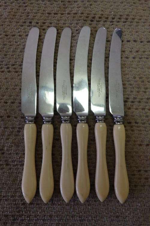 A STUNNING SET OF SIX VINTAGE BONE HANDLE STYLE STAINLESS BREAD & BUTTER KNIVES WITH SHAPED HANDLES
