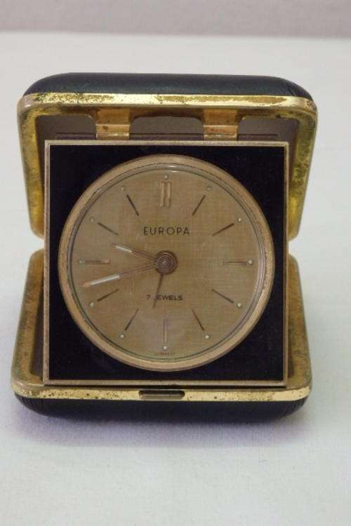 A STUNNING VINTAGE GERMAN MADE EUROPA 7 JEWEL COMPACT BESIDE WIND-UP TRAVEL ALARM CLOCK
