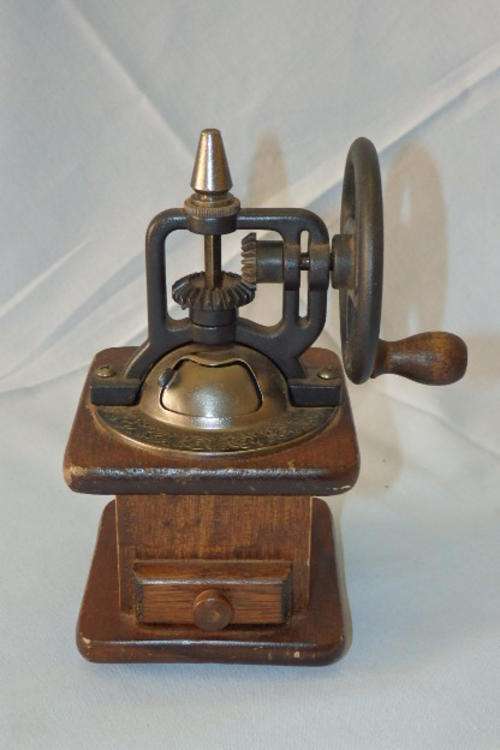 AN AWESOME VINTAGE METAL AND WOOD SPICE GRINDER WITH AN ENCLOSED HOLDER AND "MECHANICAL" GEARS