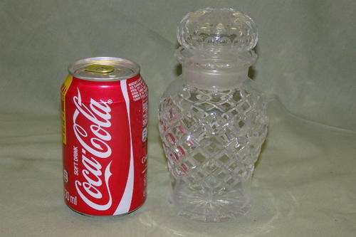 A SPECTACULAR CUT CRYSTAL SALTS BOTTLE WITH STUNNING DESIGN DETAILING AND A CRYSTAL STOPPER