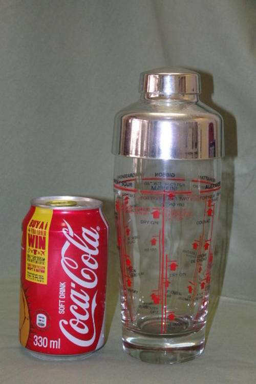 AN AWESOME GLASS COCKTAIL SHAKER WITH WELL-KNOWN COCKTAIL RECIPES ON THE SIDE OF THE SHAKER