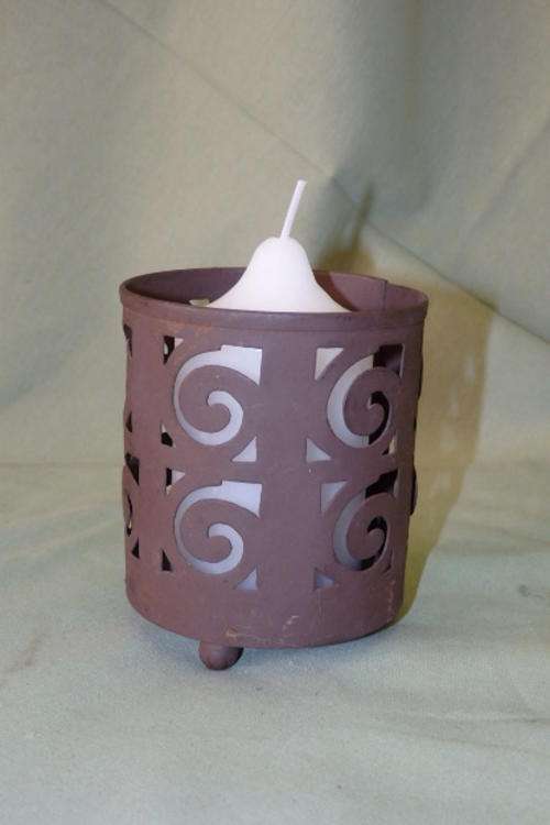 A VERY PRETTY INDIAN MADE "PUNCHED" METAL CANDLE HOLDER WITH A "RUST" EFFECT DETAILING