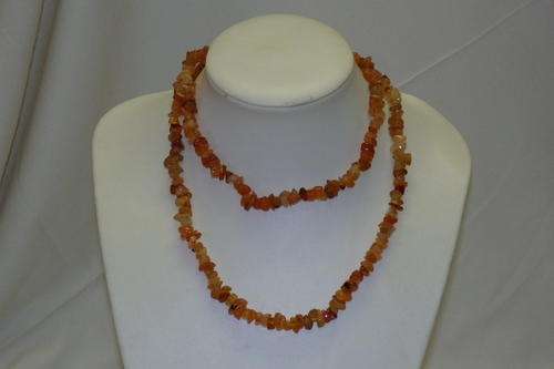 A BEAUTIFUL LONG SINGLE STRAND NECKLACE OF "APRICOT" COLOURED CARNELIAN STONES