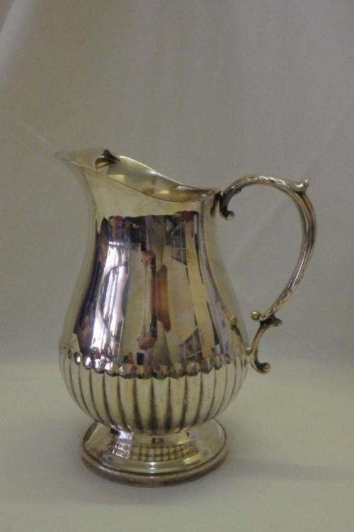 AN AWESOME "FOOTED" SILVER PLATED WATER JUG/ PITCHER WITH AN ICE LIP AND DETAILED BASE