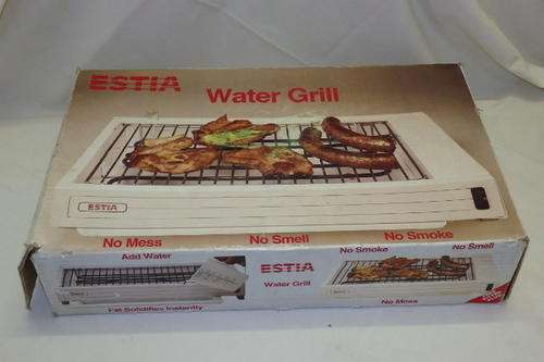 A FANTASTIC ESTIA WATER GRILL IN ITS ORIGINAL BOX WITH THE ENAMEL WATER TRAY IN THE BASE