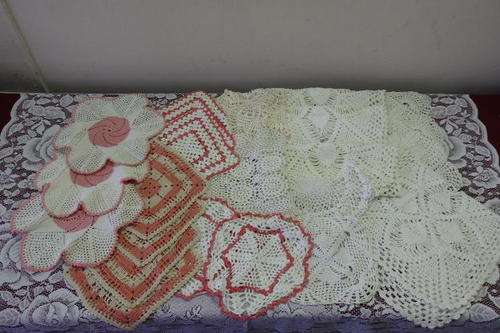 AN INCREDIBLE COLLECTION OF 23 ASSORTED HAND CROCHETED TRAY DOILIES IN VARIOUS SHAPES AND SIZES
