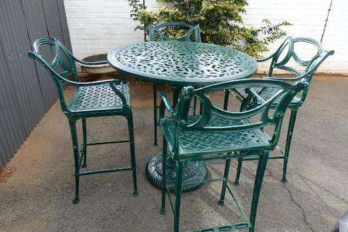 A MAGNIFICENT SOLID CAST IRON HIGH PATIO TABLE WITH MAGNIFICENT DETAIL PLUS 4 HIGH CHAIRS!!!