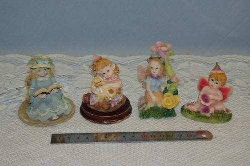 A BEAUTIFUL COLLECTION OF FOUR HAND PAINTED RESIN ORNAMENTS INCLUDING TWO FAIRY ORNAMENTS