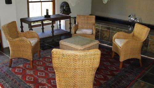 WOW! A GORGEOUS CANE WICKER SUITE INCL 4 CHAIRS WITH CUSHIONS & CENTRE TABLE IN GREAT CONDITION!