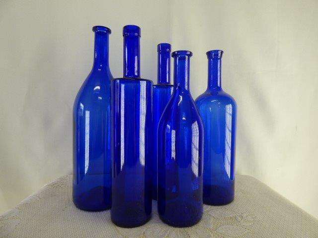 FIVE LOVELY , DIFFERENT SHAPED AND SIZED BLUE GLASS BOTTLES. GORGEOUS ON THEIR OWN.