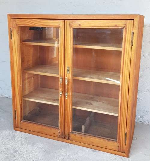 A solid Oregon pine cabinet with glass doors and wood shelves. Stunning in any home!!