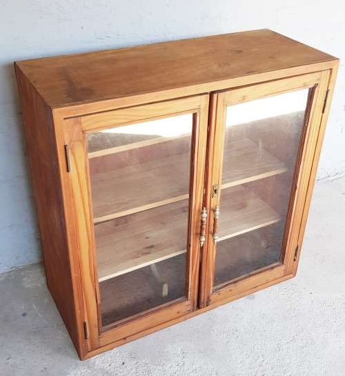 A solid Oregon pine cabinet with glass doors and wood shelves. Stunning in any home!!