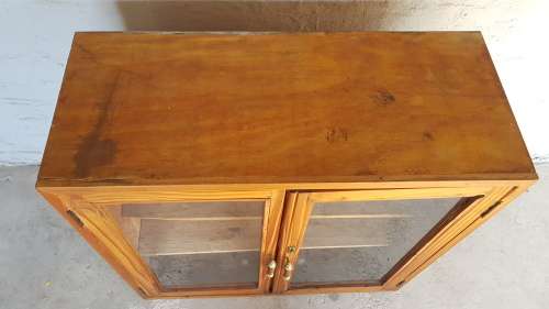 A solid Oregon pine cabinet with glass doors and wood shelves. Stunning in any home!!