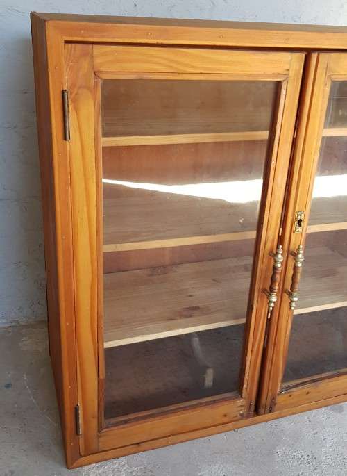 A solid Oregon pine cabinet with glass doors and wood shelves. Stunning in any home!!